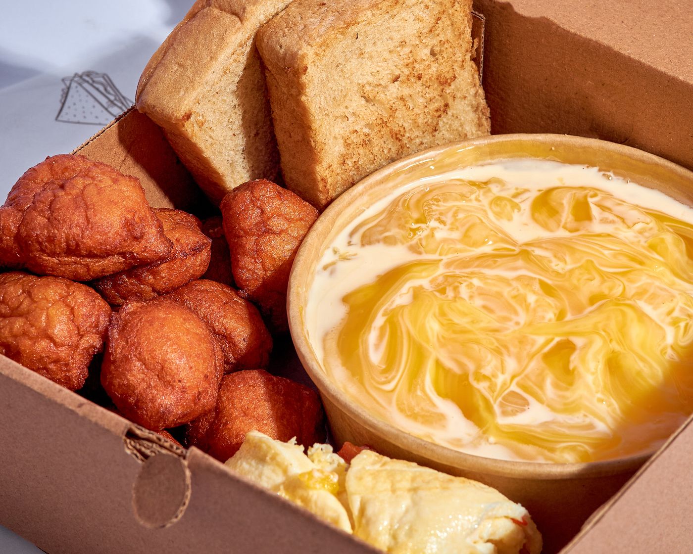 Breakfast box with akara, pap and bread