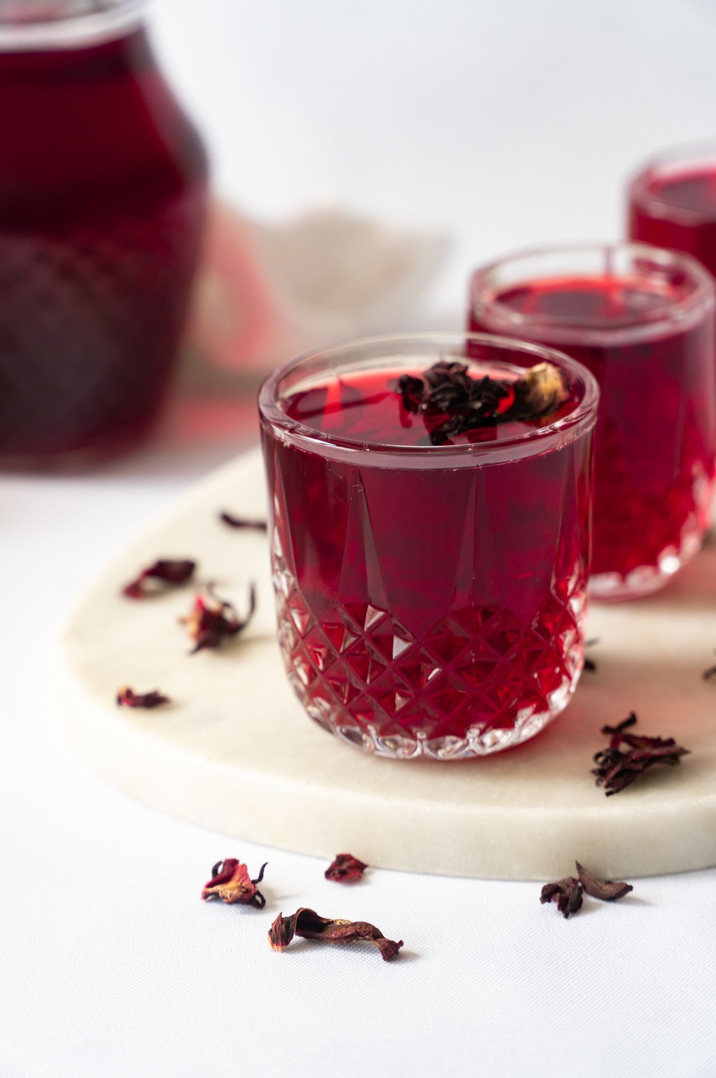 Glasses of chilled zobo with hibiscus petals
